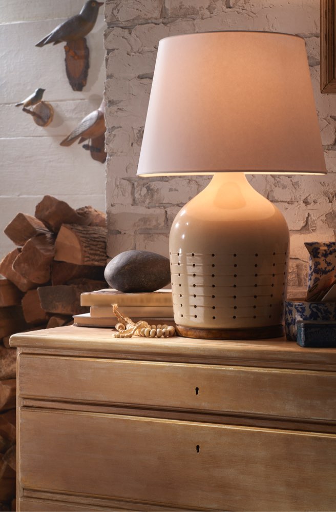 Shaded table lamp designed with geometric holes at the base