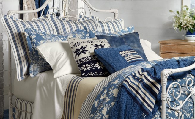 Bed with comforter, blankets, pillows & sheeting featuring indigo floral & stripes