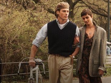 Man and woman walking in park wear classic Polo apparel.